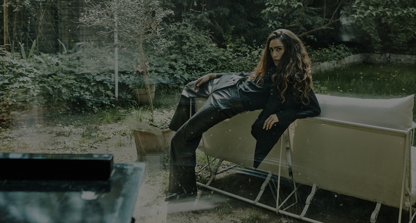 Femme en tenue de cuir sur un canapé de jardin