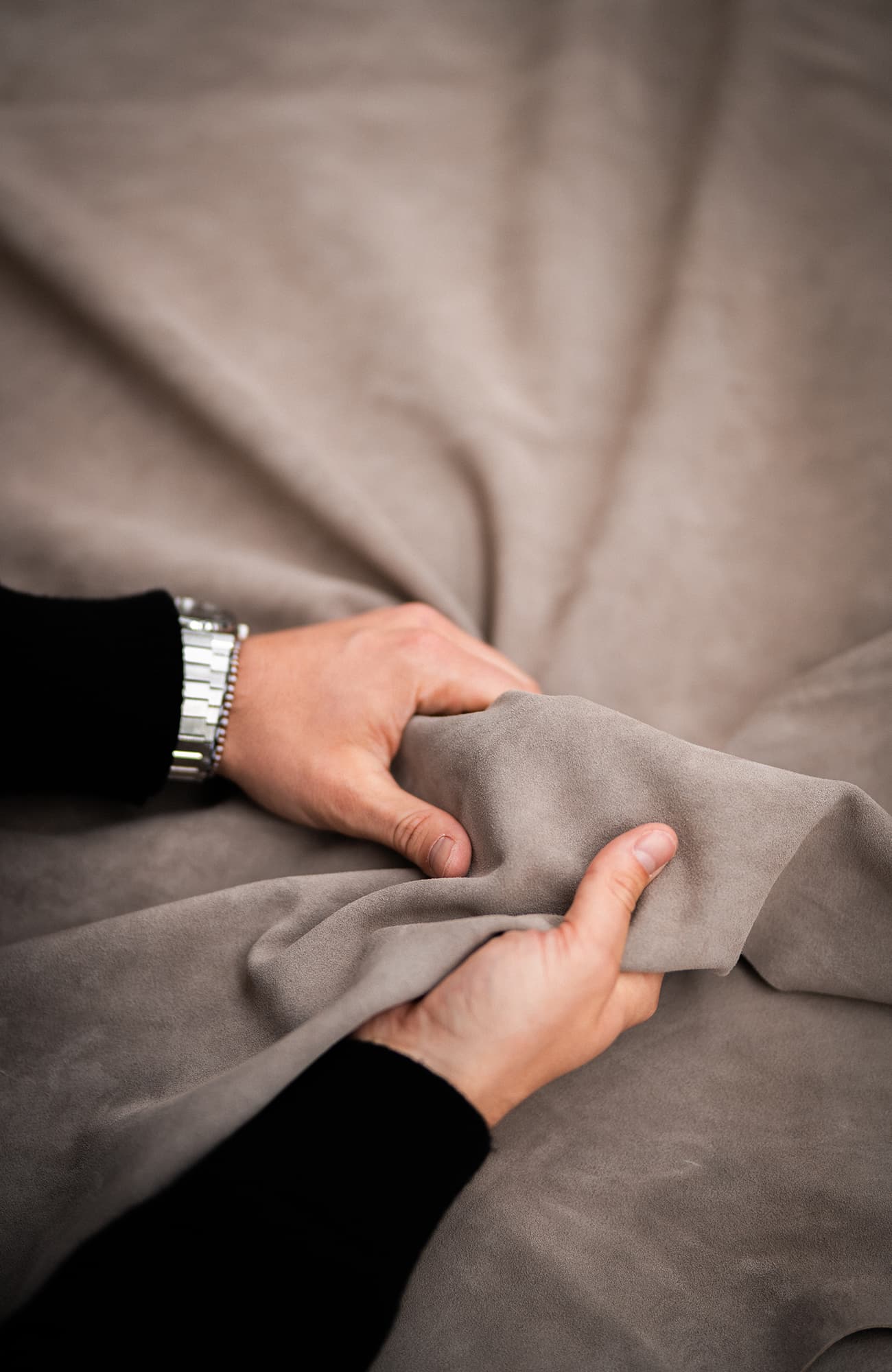 Mains vérifiant le toucher d'un morceau de cuir